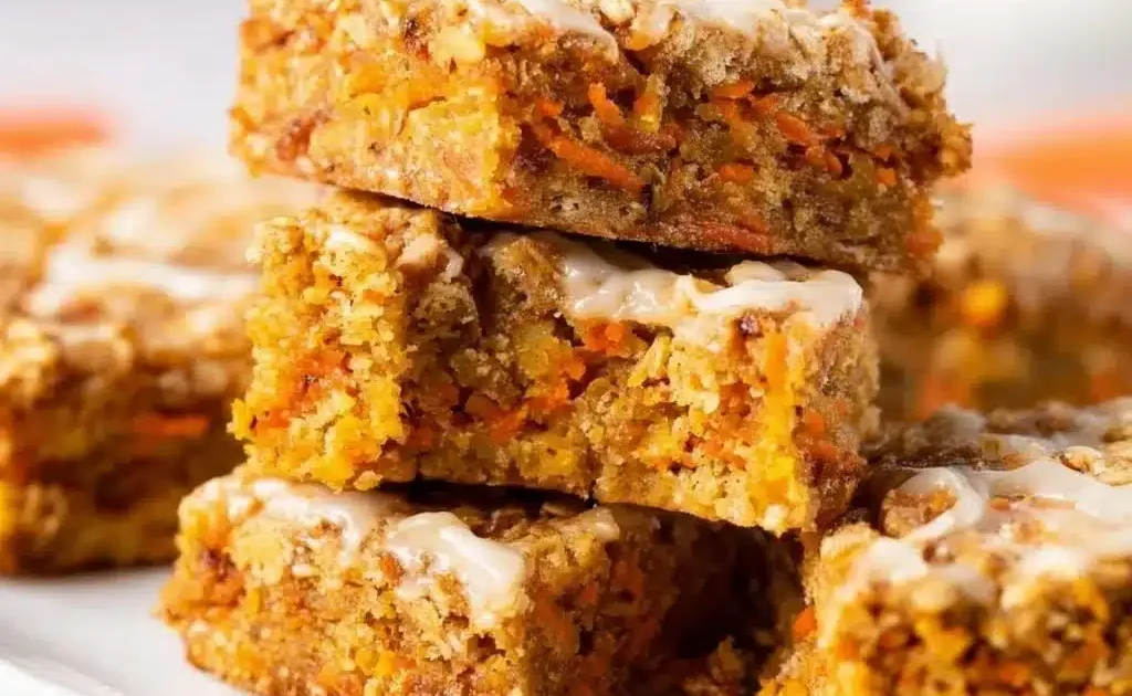 4 Ingredient Carrot Cake Oatmeal Bars topped with cream cheese frosting.