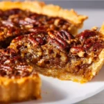 Delicious Caramel Pecan Pie topped with caramel and pecans