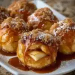 Gooey apple caramel bombs with melted caramel dripping down the sides.