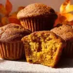 Freshly baked pumpkin spice muffins topped with cinnamon and sugar
