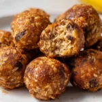 Banana Bread Energy Bites on a plate surrounded by bananas and nuts