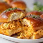 Buffalo Chicken Sliders served on a platter with sauce and garnishes