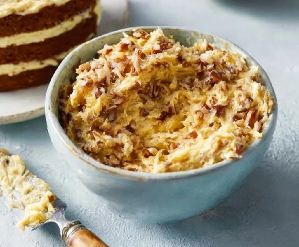 Coconut pecan spread jar with a spoon, ideal for breakfast and desserts.