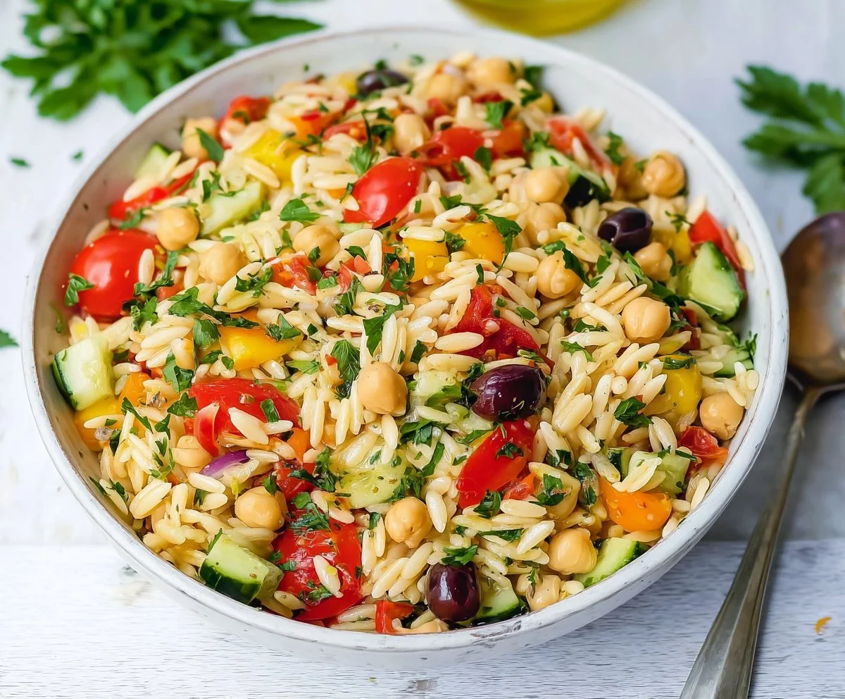 Bowl of easy orzo salad with fresh vegetables and herbs