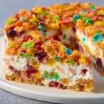 No-Bake Fruity Pebbles Cheesecake topped with colorful cereal