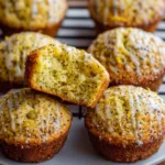 Freshly baked lemon poppy seed muffins on a cooling rack