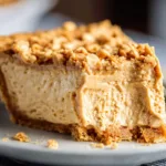 Old fashioned peanut butter pie topped with whipped cream and chocolate drizzle.