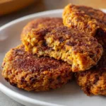 Pecan cheese veggie patties served with fresh vegetables on a plate.