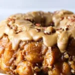 Pull Apart Praline Monkey Bread with gooey caramel and nuts on a wooden table