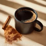Cup of cinnamon MCT oil coffee with a sprinkle of cinnamon on top.