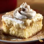 Delicious Eggnog Poke Cake topped with creamy frosting and festive decorations.