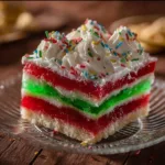 Delicious Jello Poke Cake topped with colorful jelly layers and whipped cream