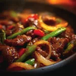 Sizzling Chinese pepper steak with onions served on a plate