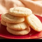 Delicious chewy sugar cookies freshly baked with a golden touch.