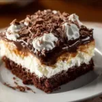 Delicious Mounds Poke Cake with chocolate and coconut toppings