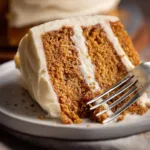 Delicious homemade spice cake topped with creamy frosting and cinnamon sprinkles.