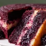 Deliciously frosted blackberry velvet cake with fresh blackberries on top.