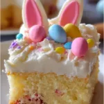 Easter Bunny Poke Cake decorated with pastel frosting and bunny ears