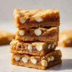 Delicious homemade blondies topped with chocolate chips and walnuts.