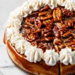 Slice of Brown Sugar Pecan Cheesecake topped with pecans and caramel drizzle