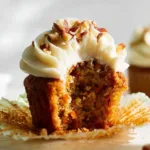 Delicious carrot cake cupcakes with cream cheese frosting on a decorative plate