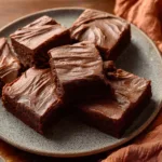 Delicious chocolate brownies with chocolate frosting on a plate