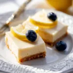 Delicious creamy lemon bars with a rich glaze on a white plate