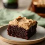 Delicious Guinness brownies with creamy Guinness frosting on a white plate