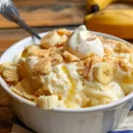 Delicious homemade banana pudding served in a glass with whipped cream topping.