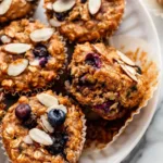 Freshly baked Blueberry Almond Power Muffins on a wooden table