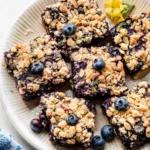 Delicious homemade blueberry pie bars displayed on a wooden table