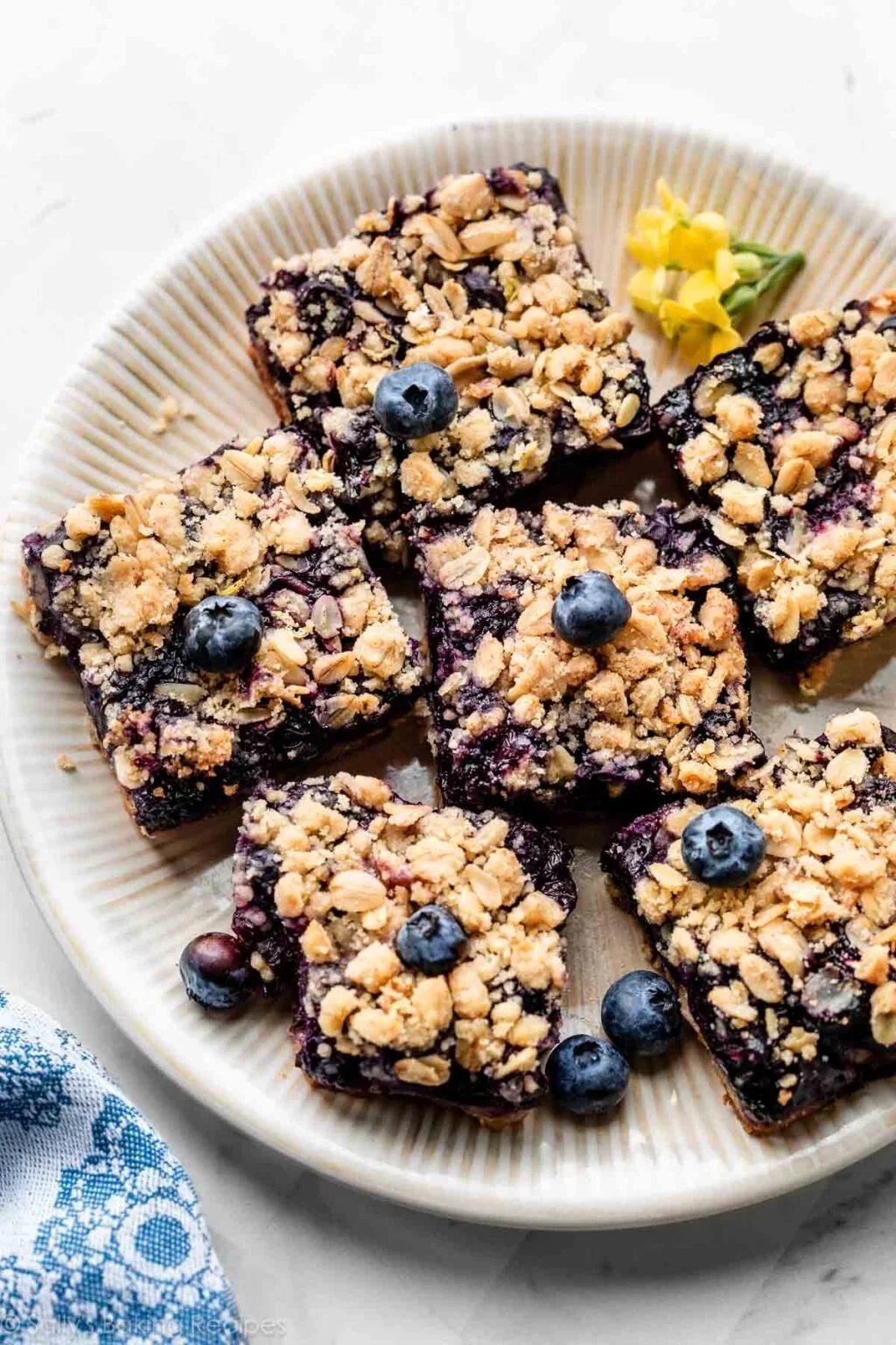 Delicious homemade blueberry pie bars displayed on a wooden table