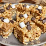 Chocolate peanut butter rice crispy treats stacked on a plate