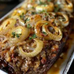 Crockpot French Onion Beefloaf served with melted cheese and herbs