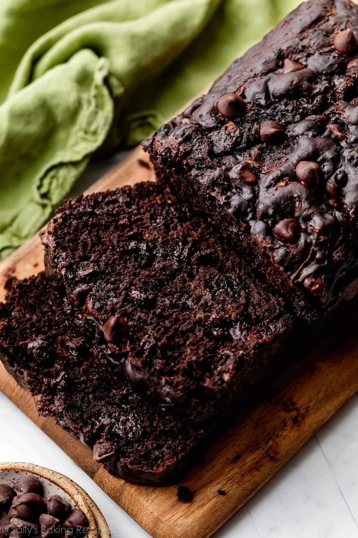 Slice of double chocolate zucchini bread with chocolate chips on top