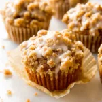 Freshly baked Pumpkin Crumb Cake Muffins with crunchy topping