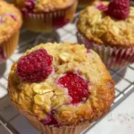 Freshly baked raspberry oatmeal muffins in a rustic setting
